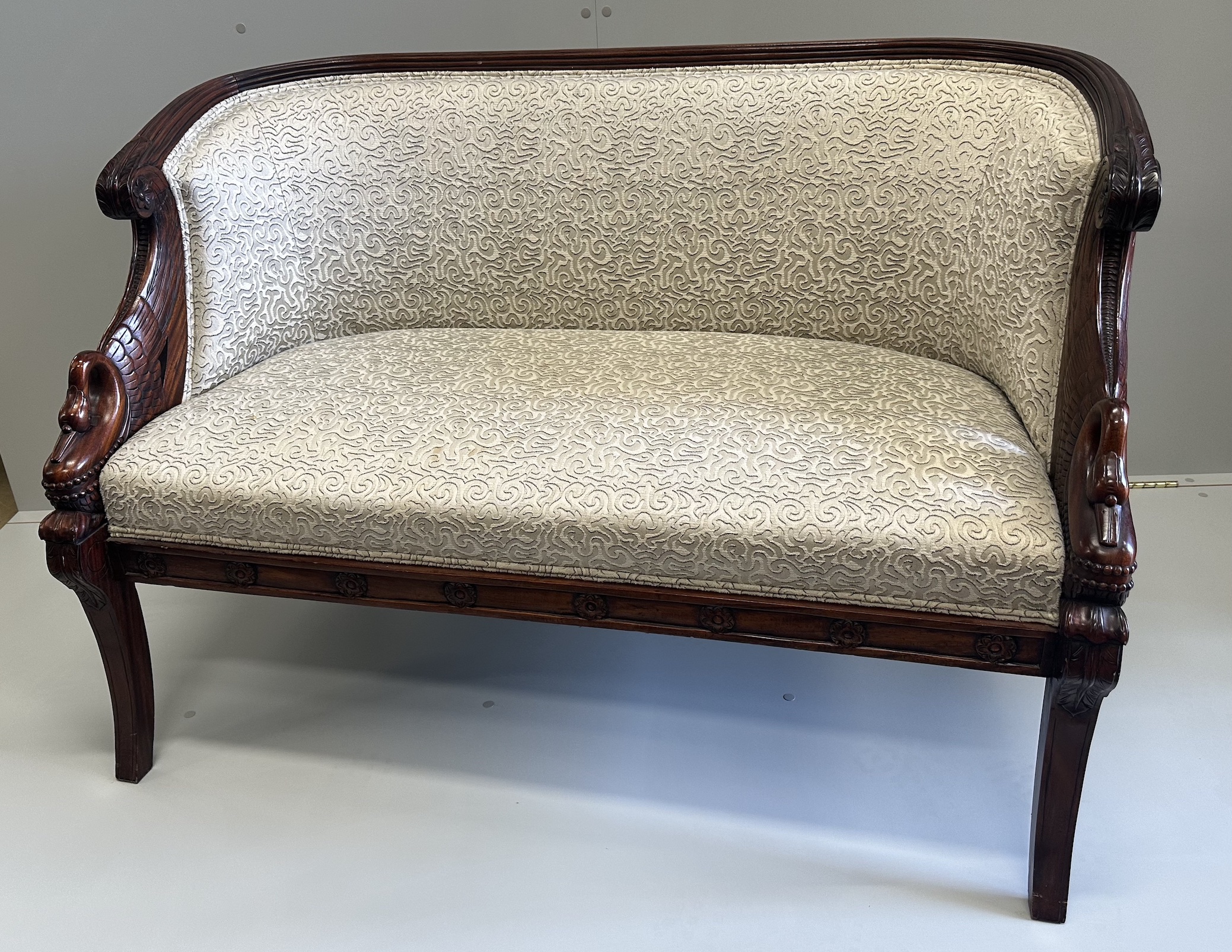 A small Regency style mahogany settee, the reeded frame with swans heads end scrolls, width 125cm, depth 64cm, height 85cm